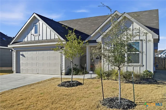 a front view of a house with a garden