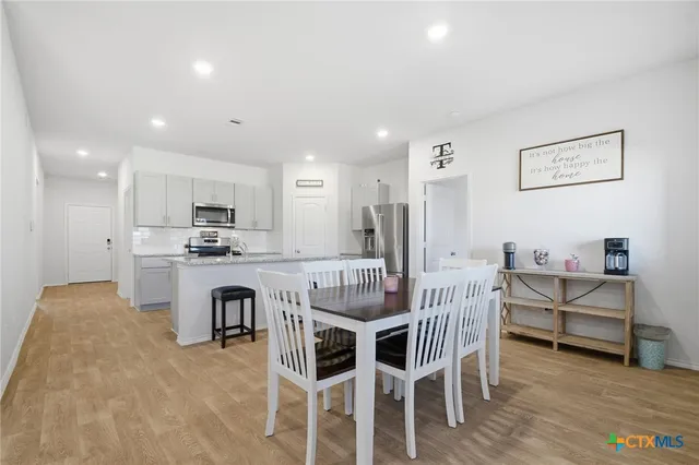 a view of kitchen with cabinets and wooden floor