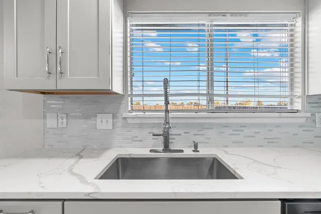 a kitchen with a sink and a window