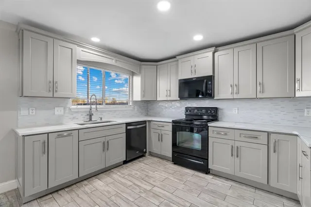 a kitchen with a sink stove and microwave