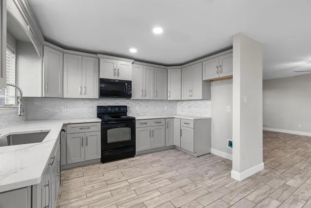 a kitchen with a sink stove and microwave
