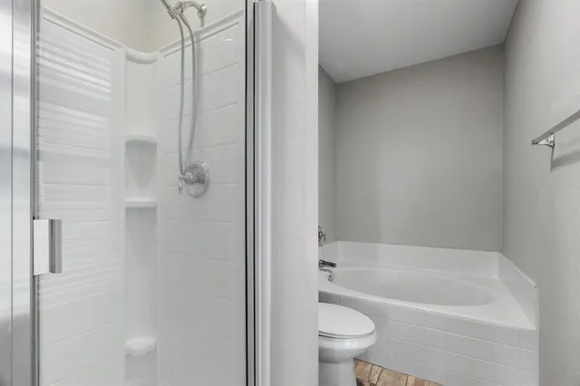 a bathroom with a bathtub and a shower