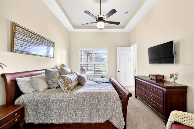 a bedroom with a bed and a dresser with the potted plant