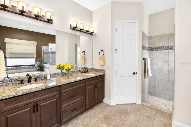 a living room with furniture kitchen view and a large window