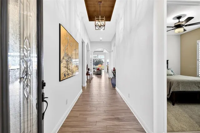 a view of a hallway with a livingroom and a hallway
