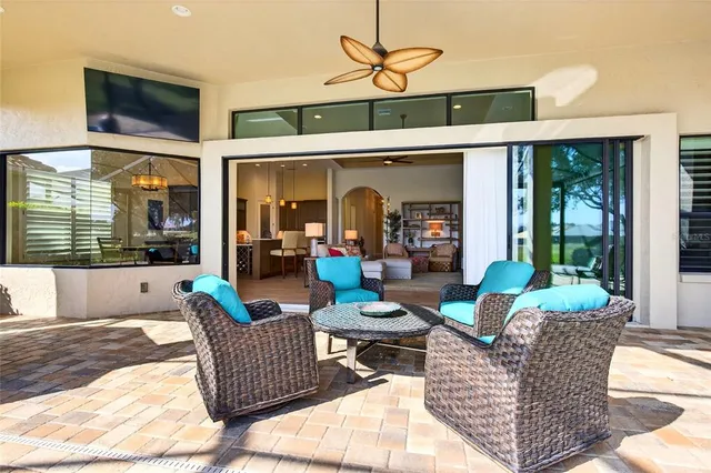 a living room with furniture a window and a flat screen tv