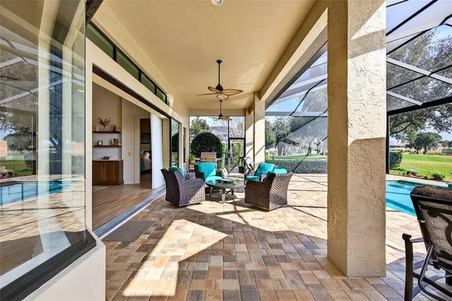 a view of swimming pool with a lounge chairs