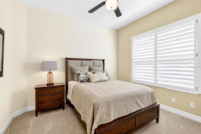 a bedroom with a bed and a night stand