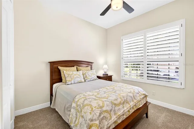 a large bed sitting in a bedroom next to a window