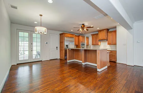 a view of a kitchen with furniture and wooden floor