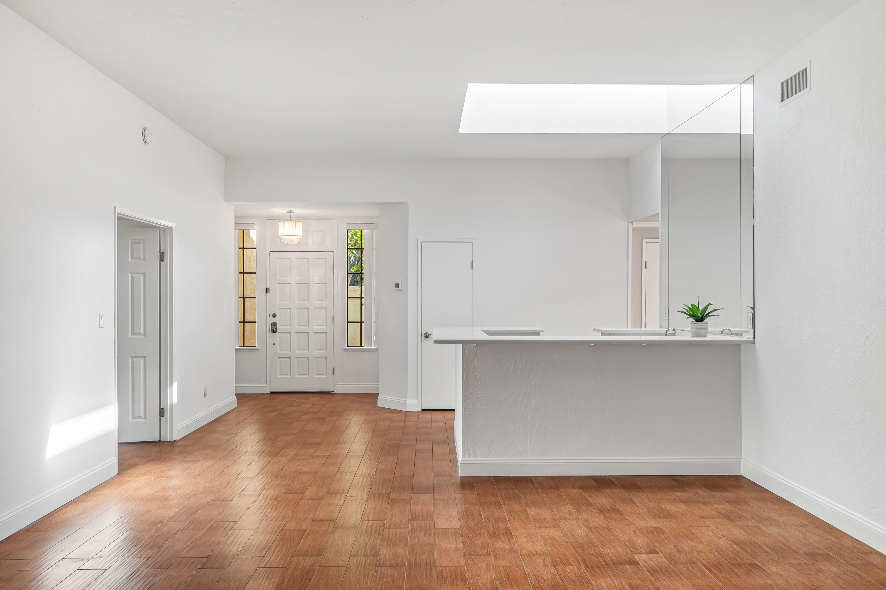 37 Santo Domingo Drive Rancho Mirage, CA 92270 - Photo 11 of 49 an empty room with wooden floor and windows