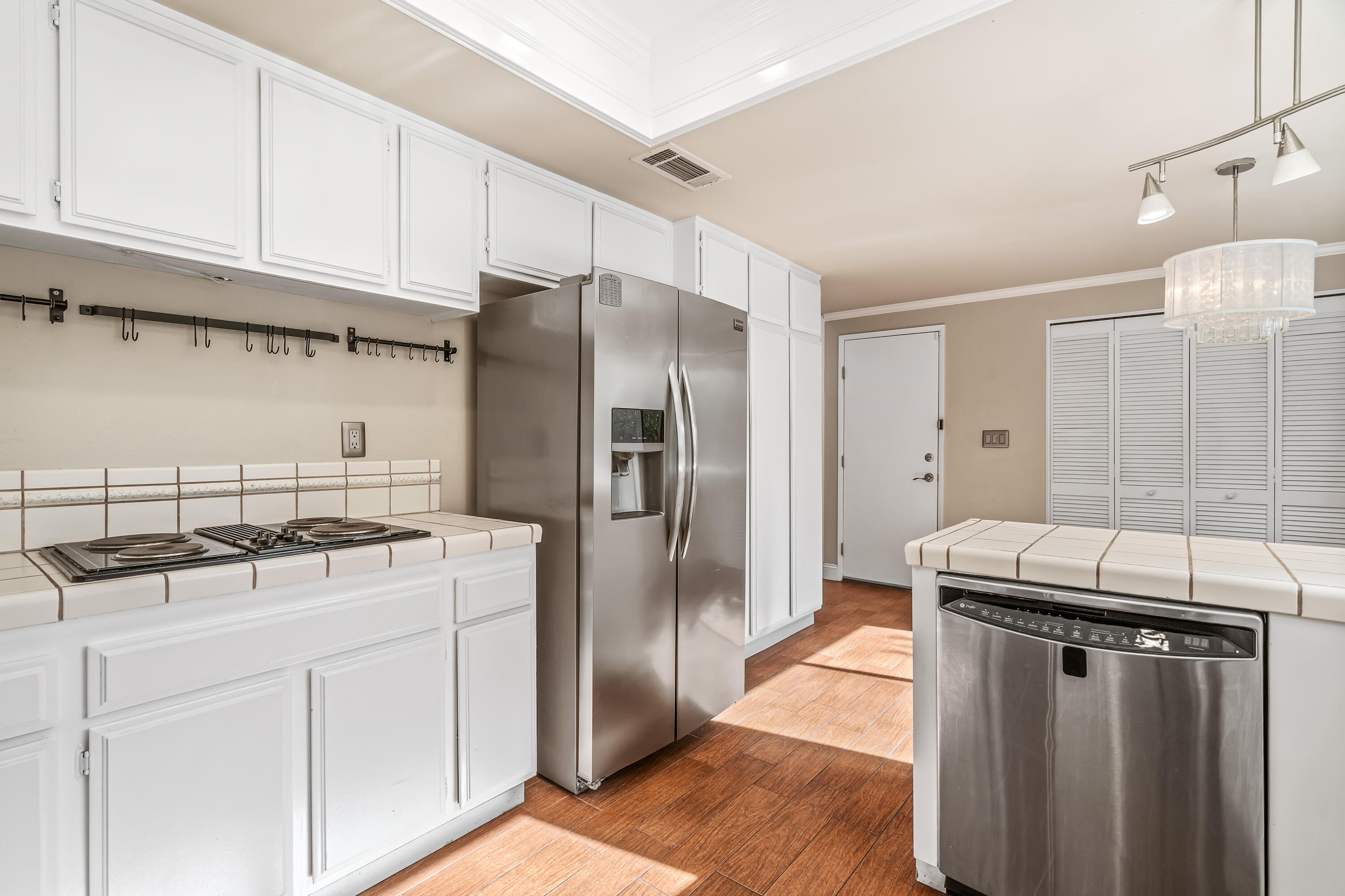 37 Santo Domingo Drive Rancho Mirage, CA 92270 - Photo 19 of 49 a kitchen with stainless steel appliances granite countertop a refrigerator a sink and white cabinets