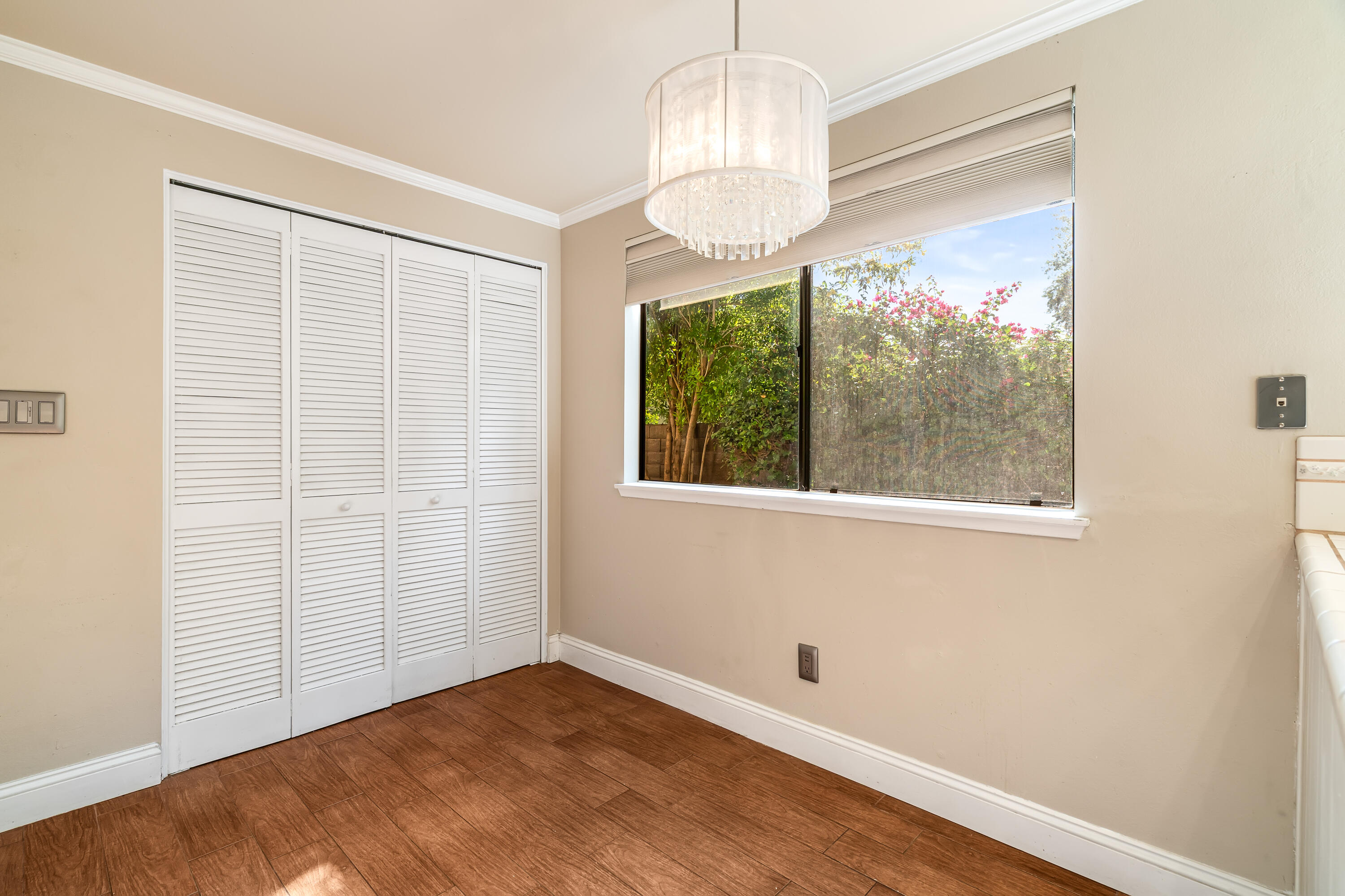 37 Santo Domingo Drive Rancho Mirage, CA 92270 - Photo 21 of 49 a view of empty room with wooden floor and chandelier