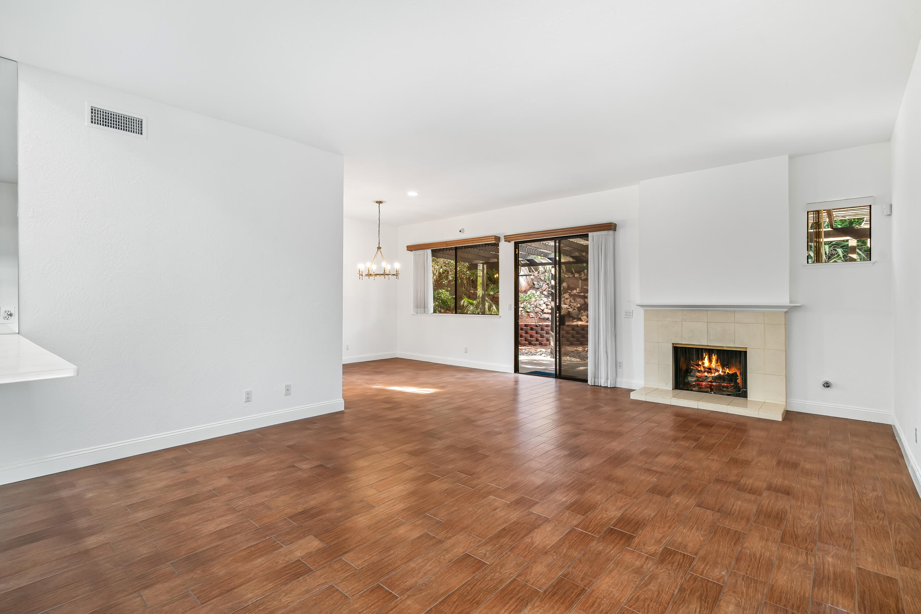 37 Santo Domingo Drive Rancho Mirage, CA 92270 - Photo 9 of 49 an empty room with fireplace and windows