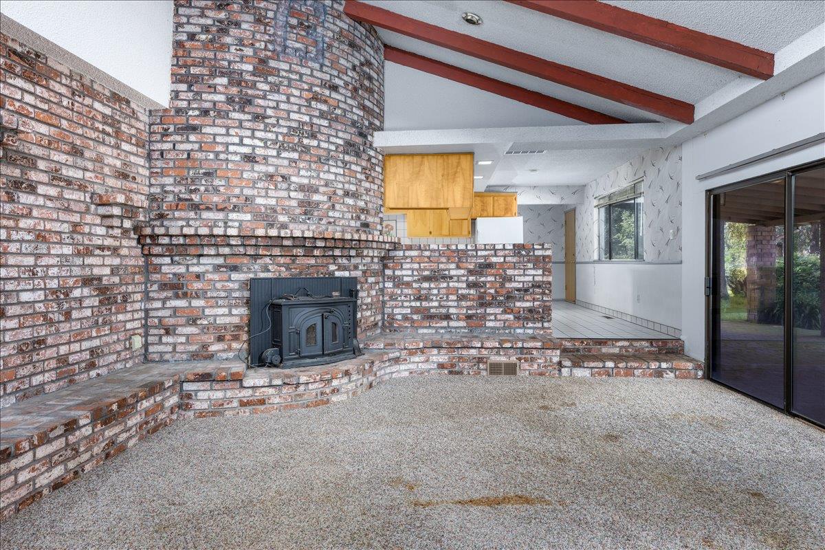 12188 Clay Station Road Herald, CA 95638 - Photo 59 of 89 Den/family room wood stove insert. Kitchen cabinets visible