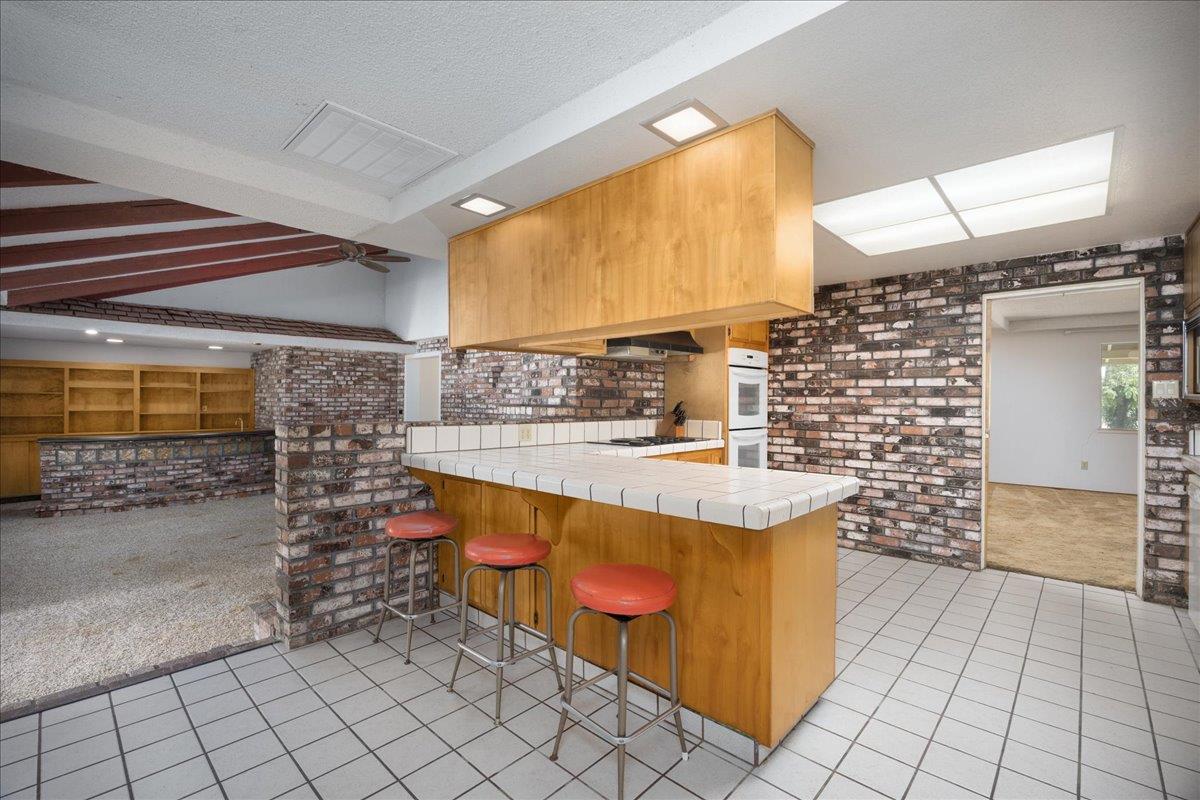 12188 Clay Station Road Herald, CA 95638 - Photo 64 of 89 Kitchen breakfast bar step down to den/family room