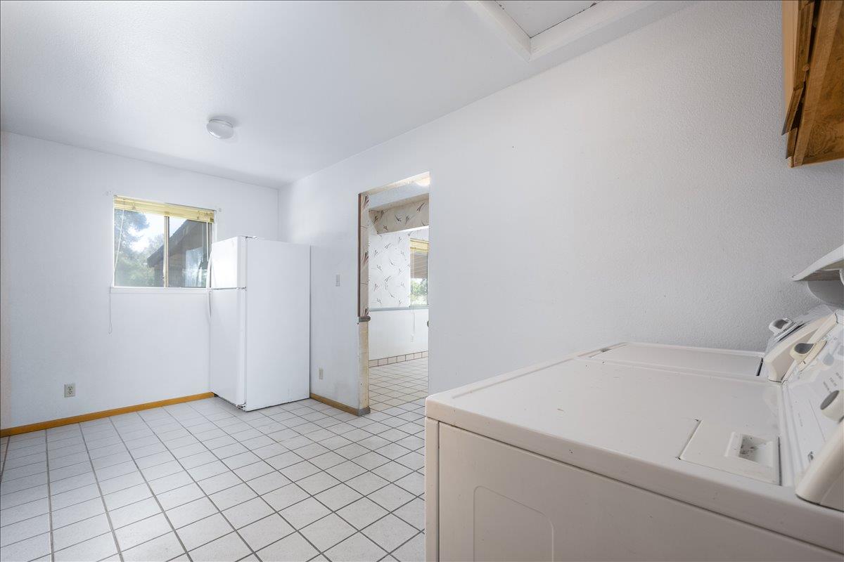 12188 Clay Station Road Herald, CA 95638 - Photo 78 of 89 Laundry room door way into kitchen and small pantry area