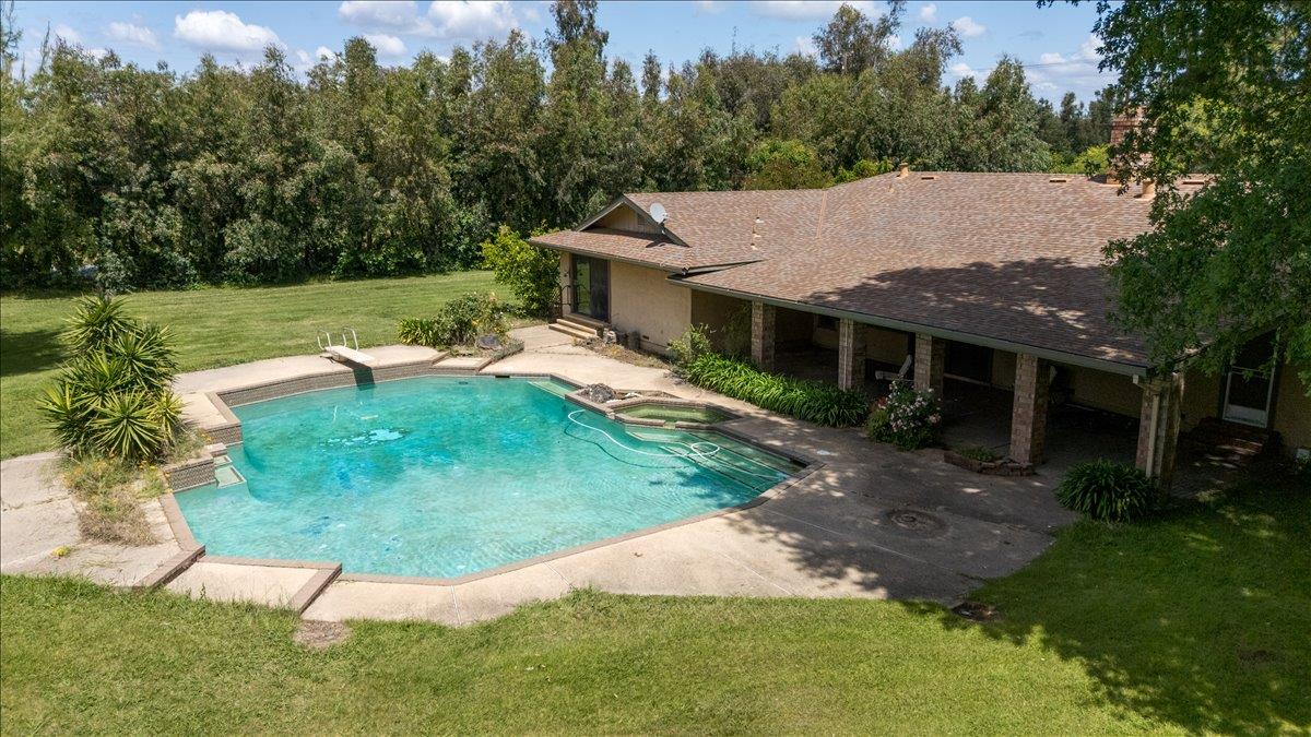 12188 Clay Station Road Herald, CA 95638 - Photo 84 of 89 Back yard pool and covered patio visible and sliding door from master bedroom