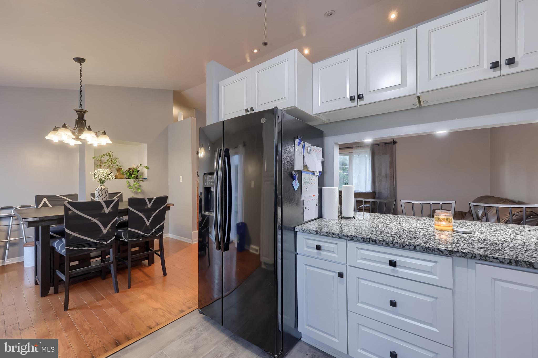 4131 Davidsburg Road Dover, PA 17315 - Photo 6 of 38 a kitchen with granite countertop a refrigerator a stove a dining table and chairs
