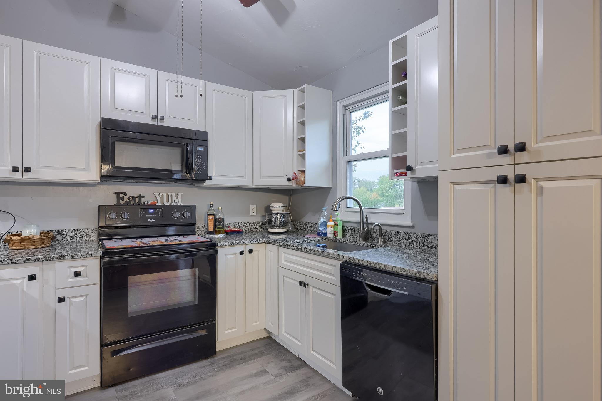 4131 Davidsburg Road Dover, PA 17315 - Photo 7 of 38 a kitchen with granite countertop white cabinets and white appliances