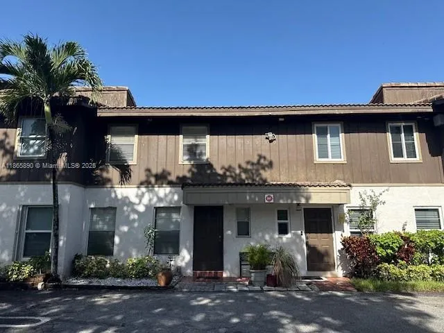a front view of a house with plants