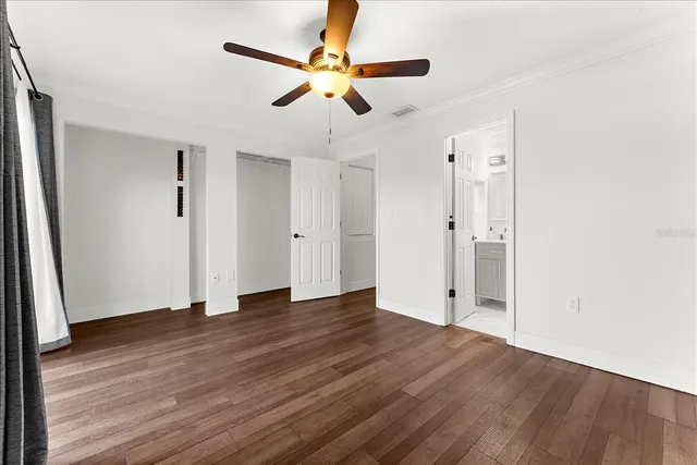 a bathroom with a granite countertop toilet a sink a mirror and shower