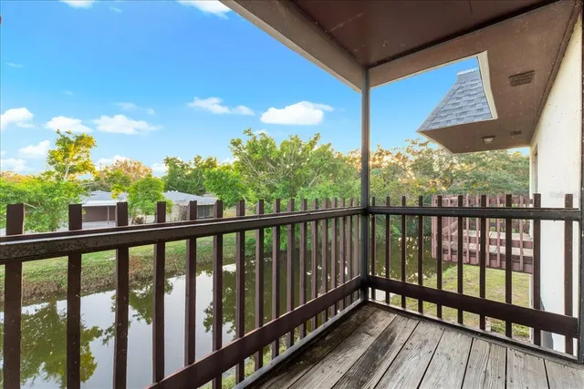a view of a balcony with floor to ceiling window wooden floor