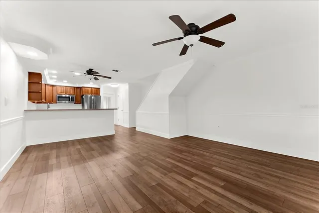 a kitchen with stainless steel appliances granite countertop cabinets wooden floors and a sink