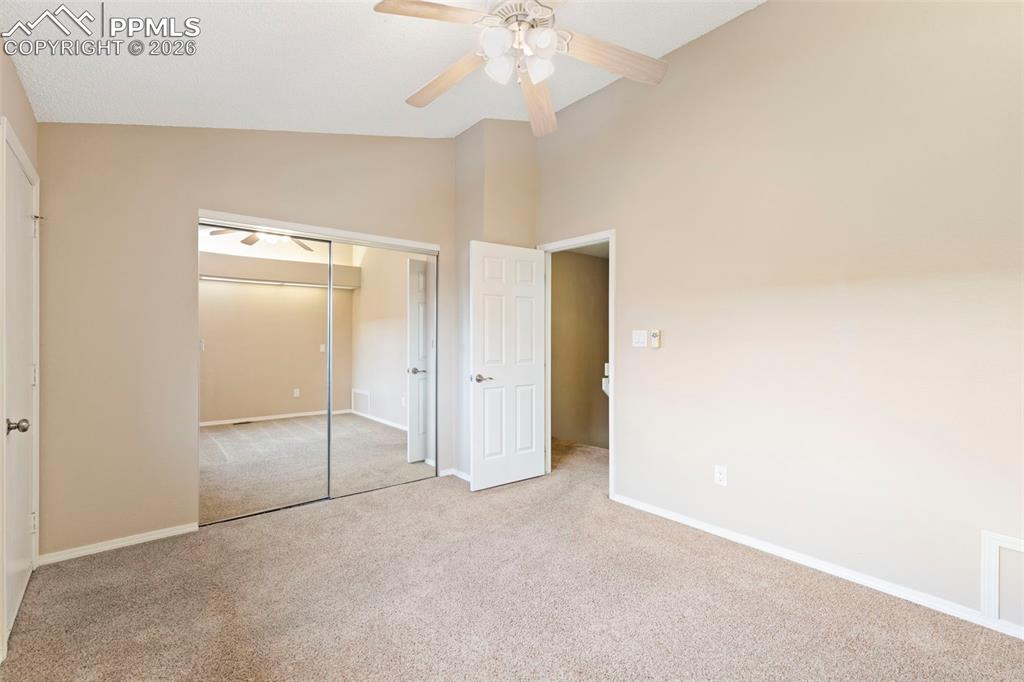 4315 Hunting Meadows Circle, Unit 1 Colorado Springs, CO 80916 - Photo 12 of 26 a view of an empty room with a ceiling fan