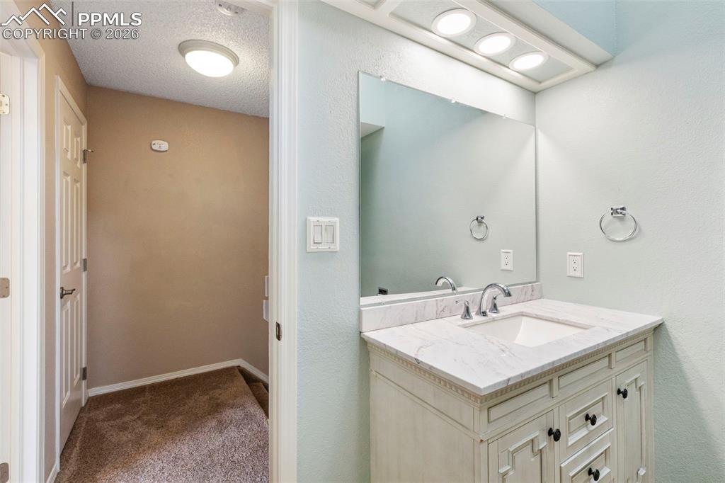 4315 Hunting Meadows Circle, Unit 1 Colorado Springs, CO 80916 - Photo 16 of 26 a bathroom with a sink mirror and vanity