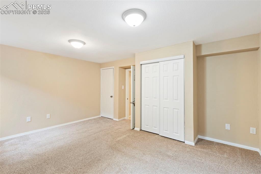 4315 Hunting Meadows Circle, Unit 1 Colorado Springs, CO 80916 - Photo 18 of 26 an empty room with closet and windows