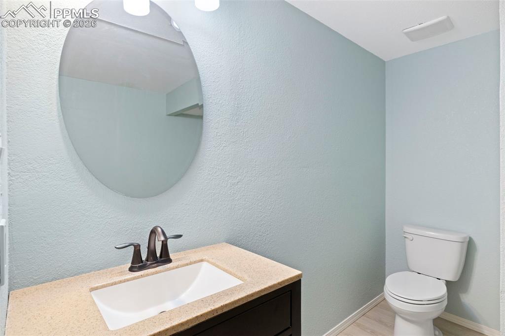 4315 Hunting Meadows Circle, Unit 1 Colorado Springs, CO 80916 - Photo 20 of 26 a bathroom with a sink a toilet and a mirror