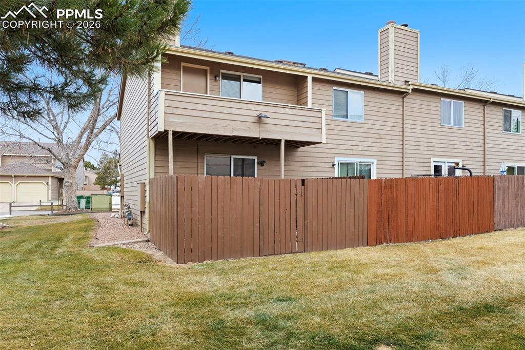4315 Hunting Meadows Circle, Unit 1 Colorado Springs, CO 80916 - Photo 25 of 26 a front view of a house with a yard