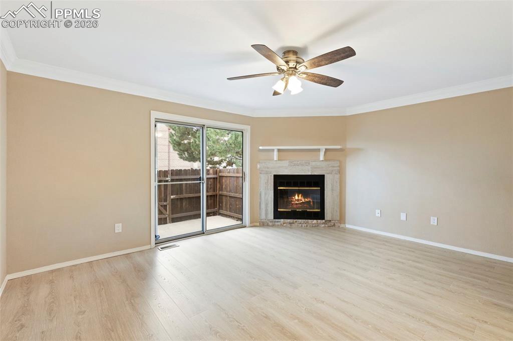 4315 Hunting Meadows Circle, Unit 1 Colorado Springs, CO 80916 - Photo 4 of 26 a view of an empty room with a window and fireplace