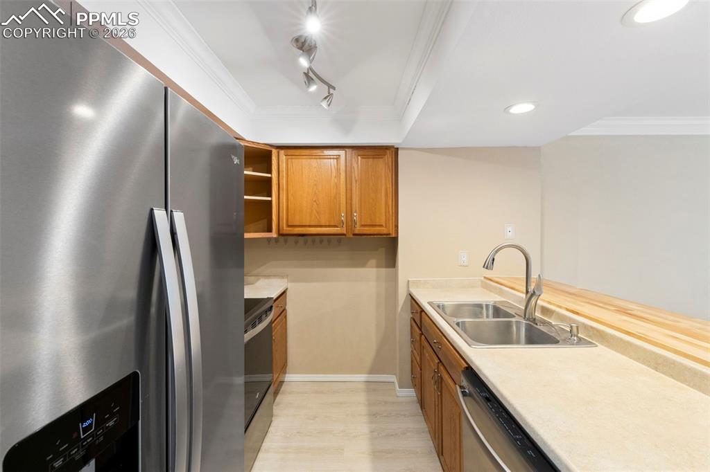 4315 Hunting Meadows Circle, Unit 1 Colorado Springs, CO 80916 - Photo 7 of 26 a kitchen with kitchen island a sink stainless steel appliances and cabinets