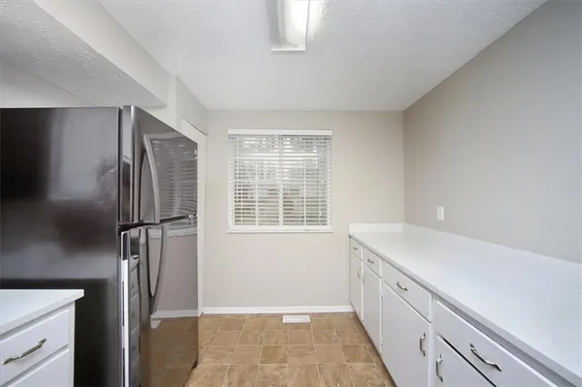 a kitchen with a refrigerator and a sink
