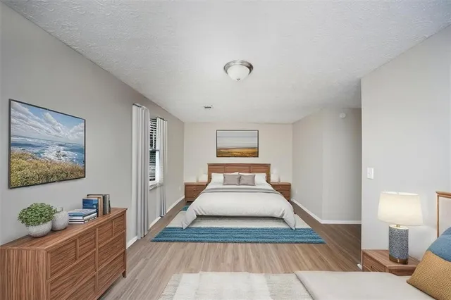 a bed room with furniture and wooden floor