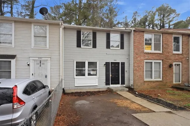 a backyard of a house with seating space and barbeque oven
