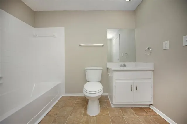 a bathroom with a toilet sink and a mirror