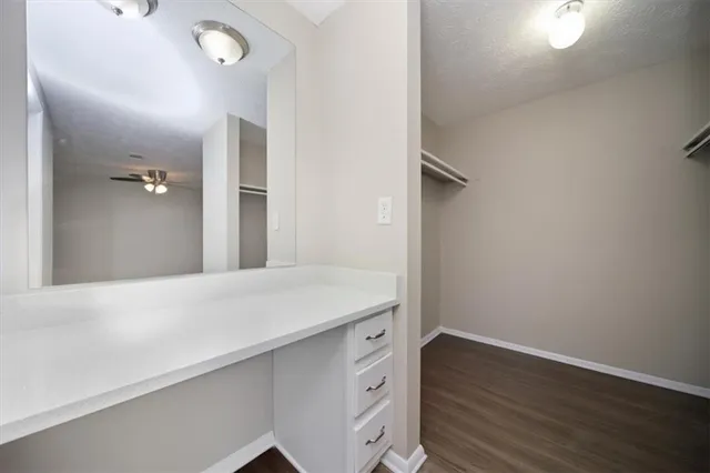 a view of a hallway with wooden floor and entryway