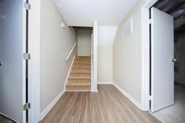 a view of a room with wooden floor and windows