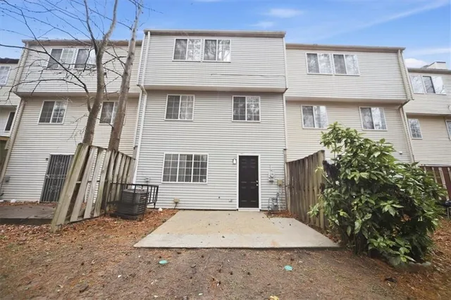 a view of a house with wooden fence