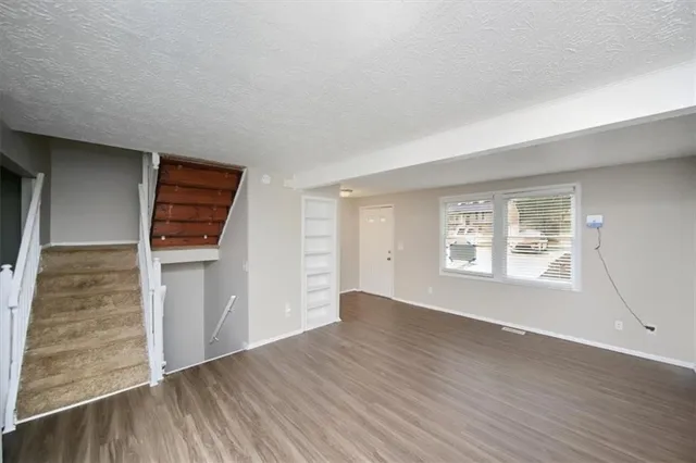 an empty room with windows and closet