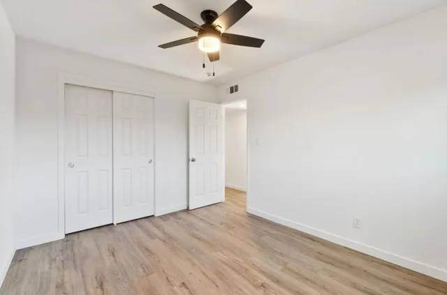 a view of an empty room and wooden floor