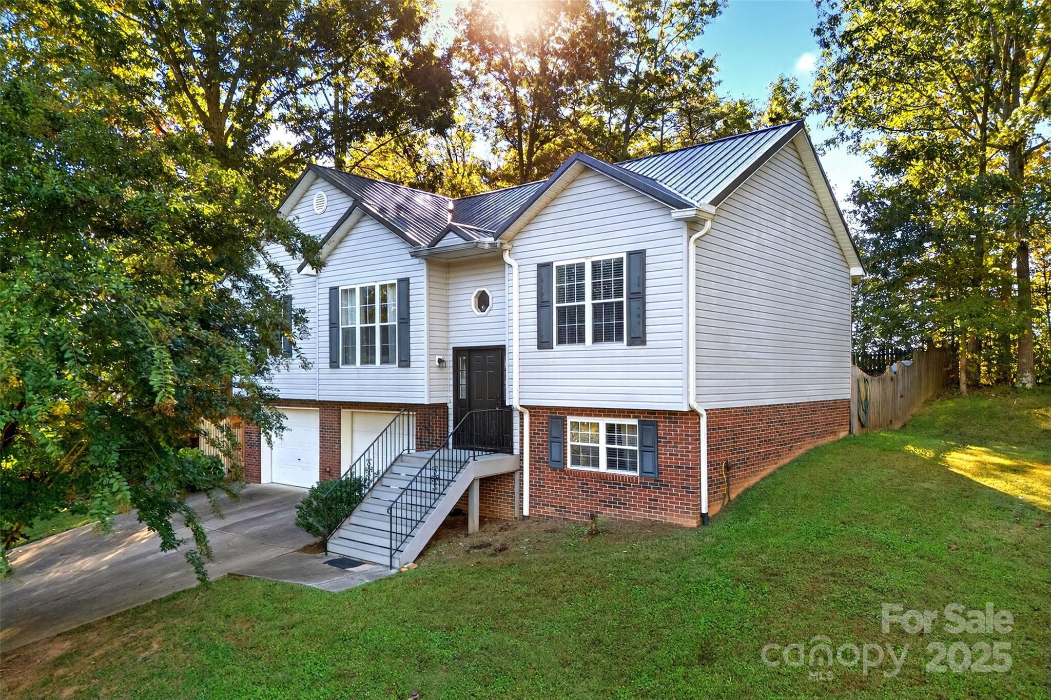 2691 Laurel Point Drive Nebo, NC 28761 - Photo 1 of 44 a front view of a house with a yard table and garage
