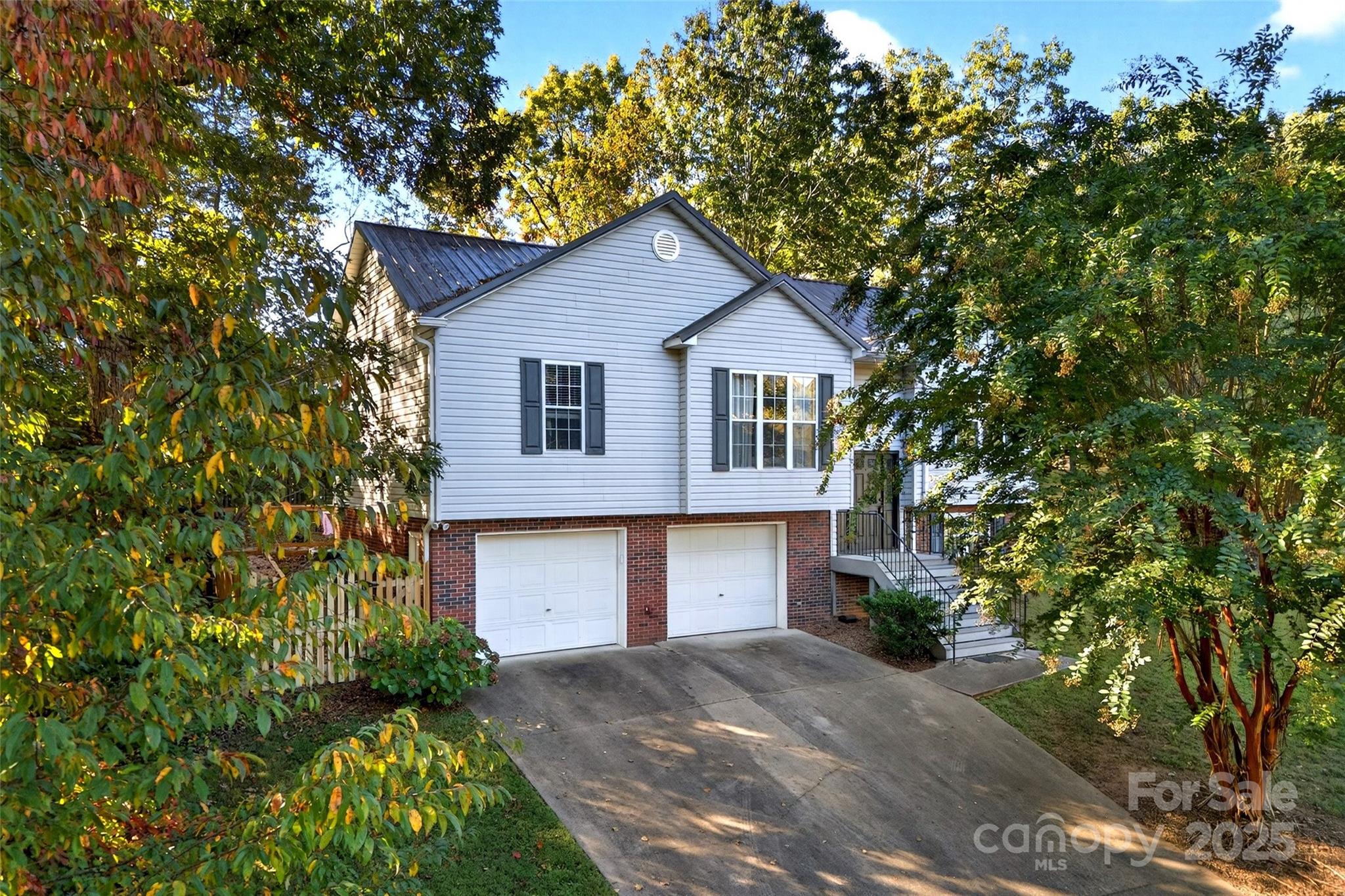2691 Laurel Point Drive Nebo, NC 28761 - Photo 2 of 44 a front view of a house with a yard and garage