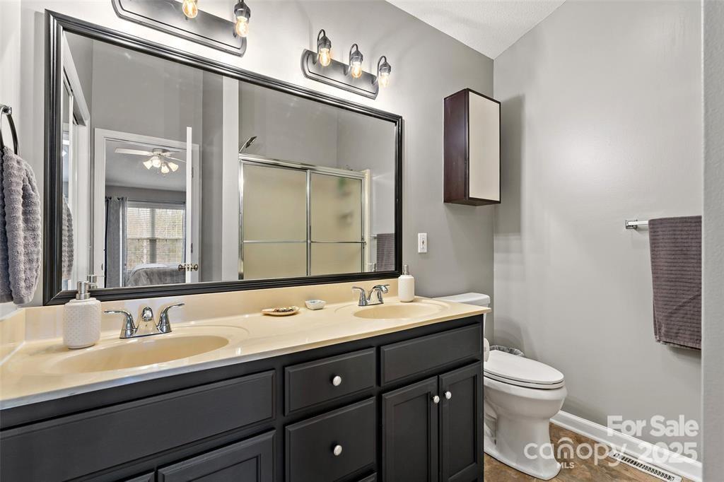 2691 Laurel Point Drive Nebo, NC 28761 - Photo 23 of 44 a bathroom with a toilet sink double and mirror