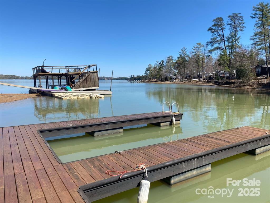 2691 Laurel Point Drive Nebo, NC 28761 - Photo 4 of 44 a view of a lake with couches chairs