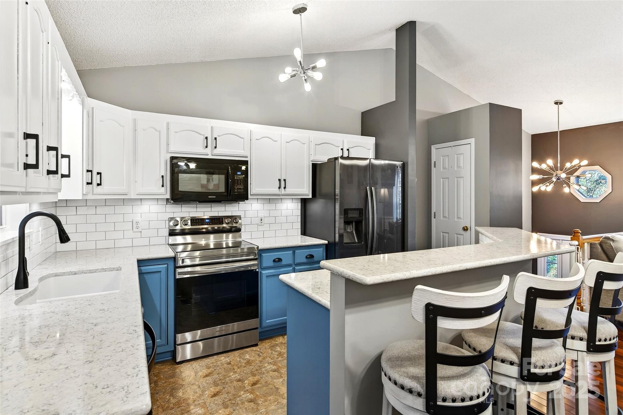2691 Laurel Point Drive Nebo, NC 28761 - Photo 7 of 44 a kitchen with stainless steel appliances kitchen island a table chairs microwave and refrigerator
