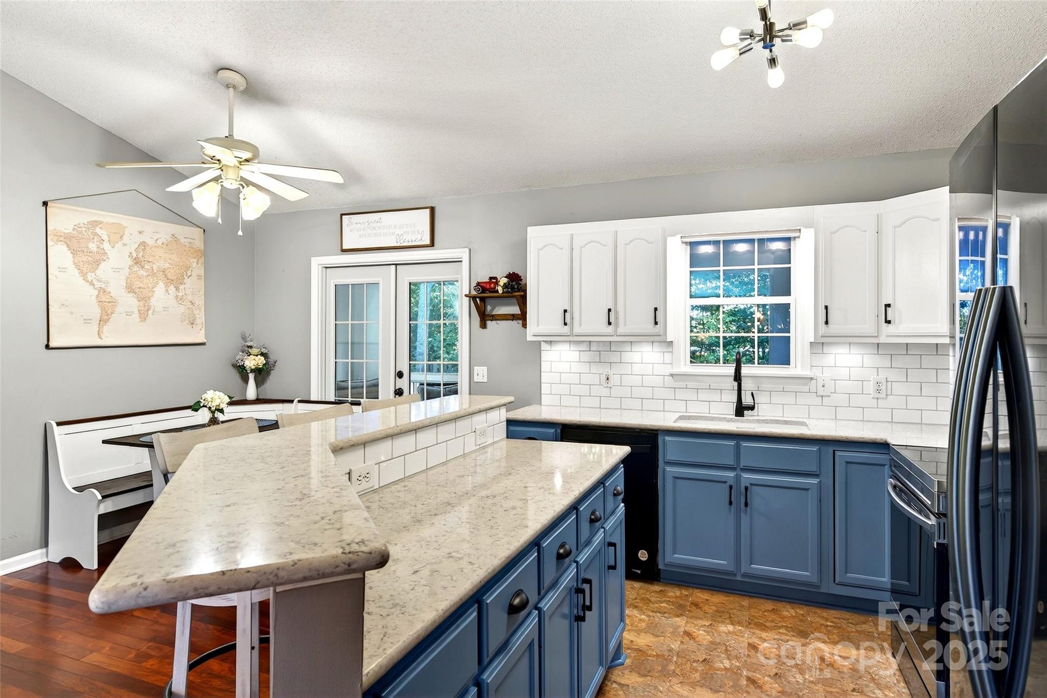 2691 Laurel Point Drive Nebo, NC 28761 - Photo 9 of 44 a kitchen with kitchen island granite countertop a stove a sink a dining table and chairs with wooden floor